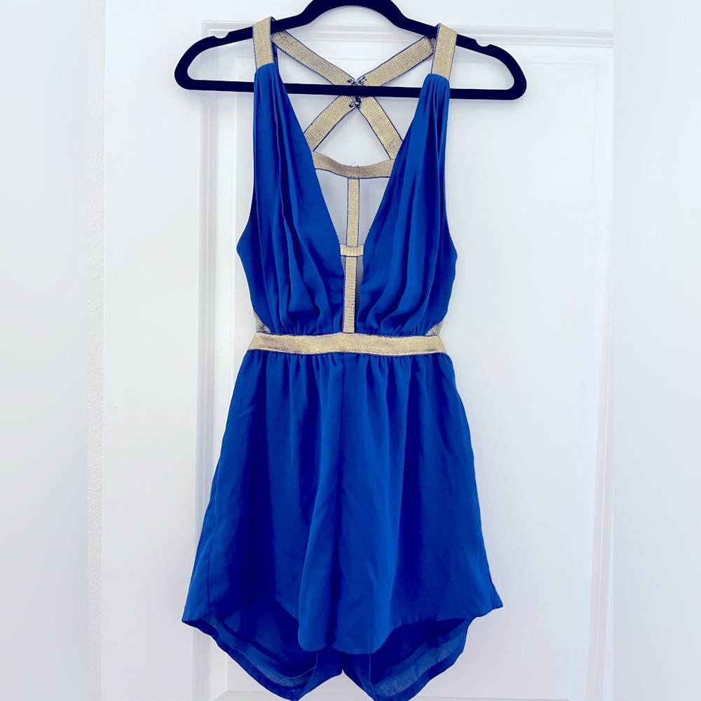 Size small vibrant blue romper with gold detailing and open back